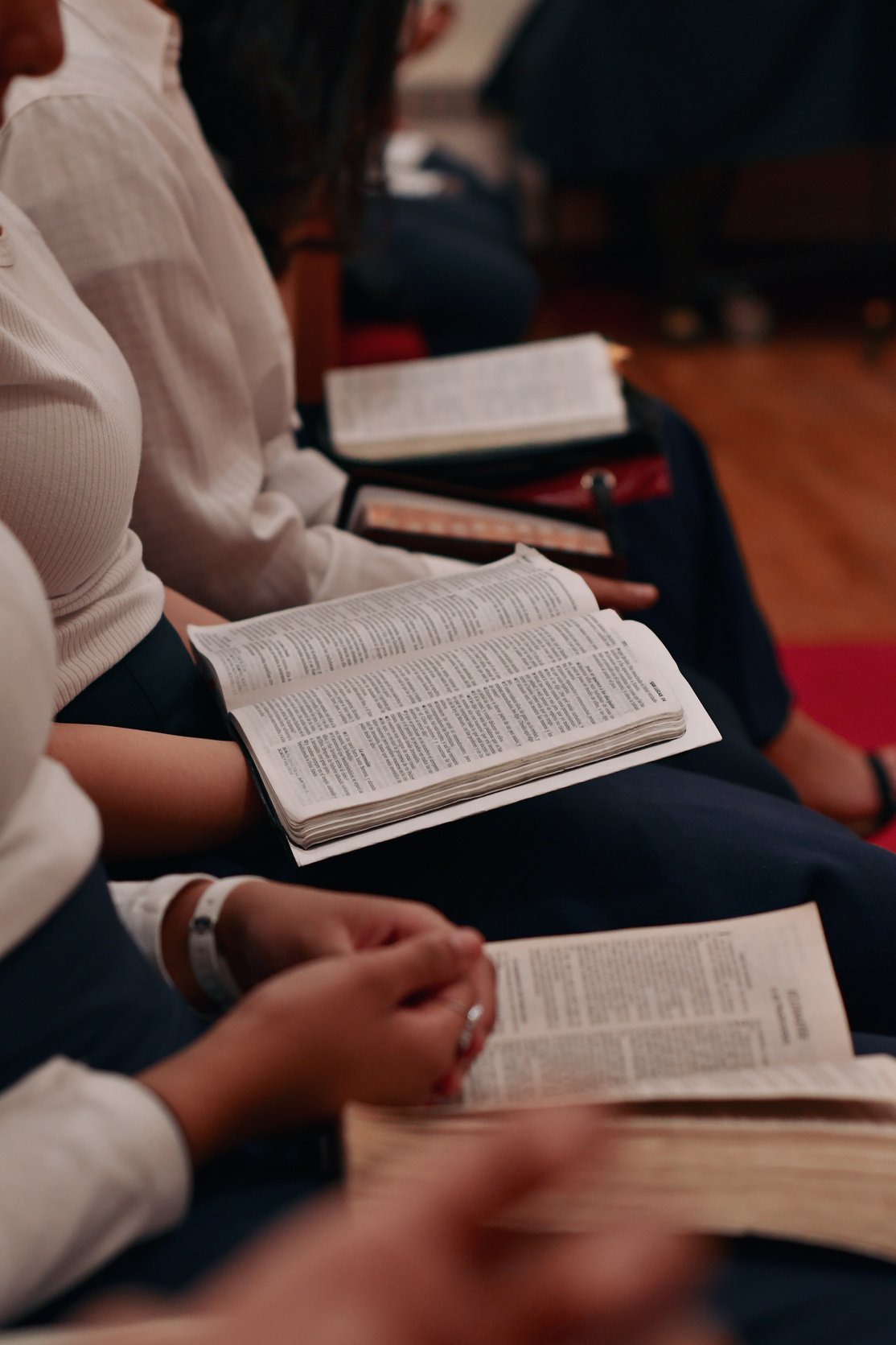 Person in White Long Sleeve Shirt Reading Book